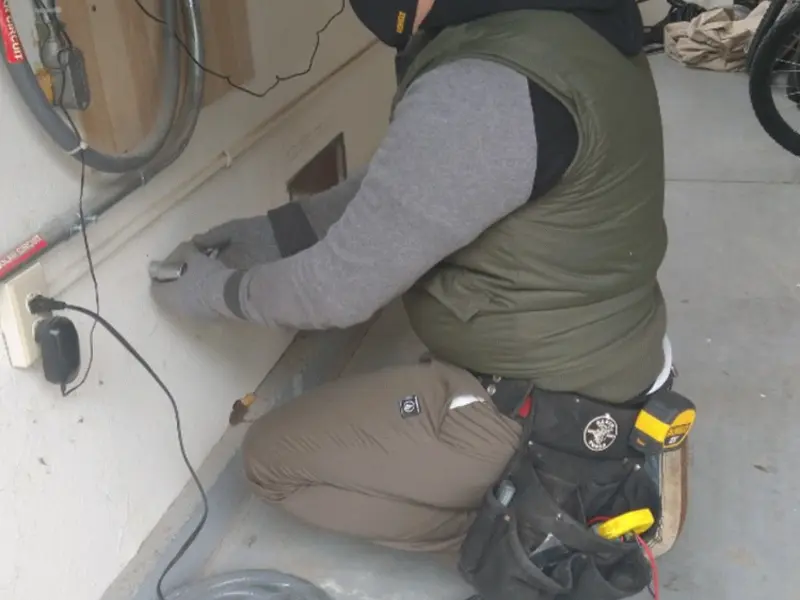 Electrician performing outlet wiring in a Umatilla garage